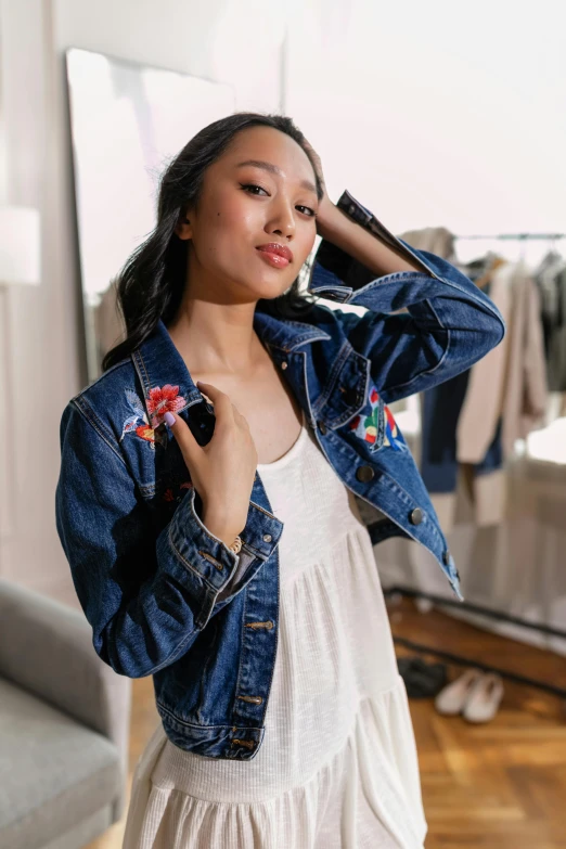 a woman in a white dress and denim jacket, by Robbie Trevino, happening, official store photo, joy ang, embroidered robes, full shot ( fs )