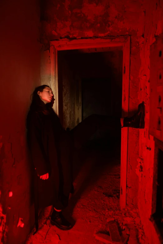 a woman in a dark room with a red light, happening, inside haunted house, leaning on door, black on red, slide show