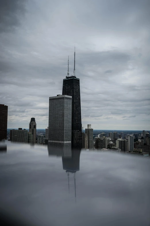 a very tall building sitting in the middle of a city, by Greg Rutkowski, unsplash contest winner, stands in a pool of water, photograph credit: ap, chicago, ap news photo