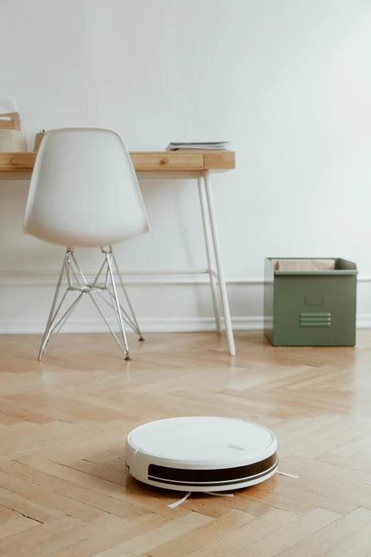 a white robot sitting on top of a hard wood floor, a picture, trending on pexels, minimalism, drum scanner, green floor, interior of a small, silver，ivory