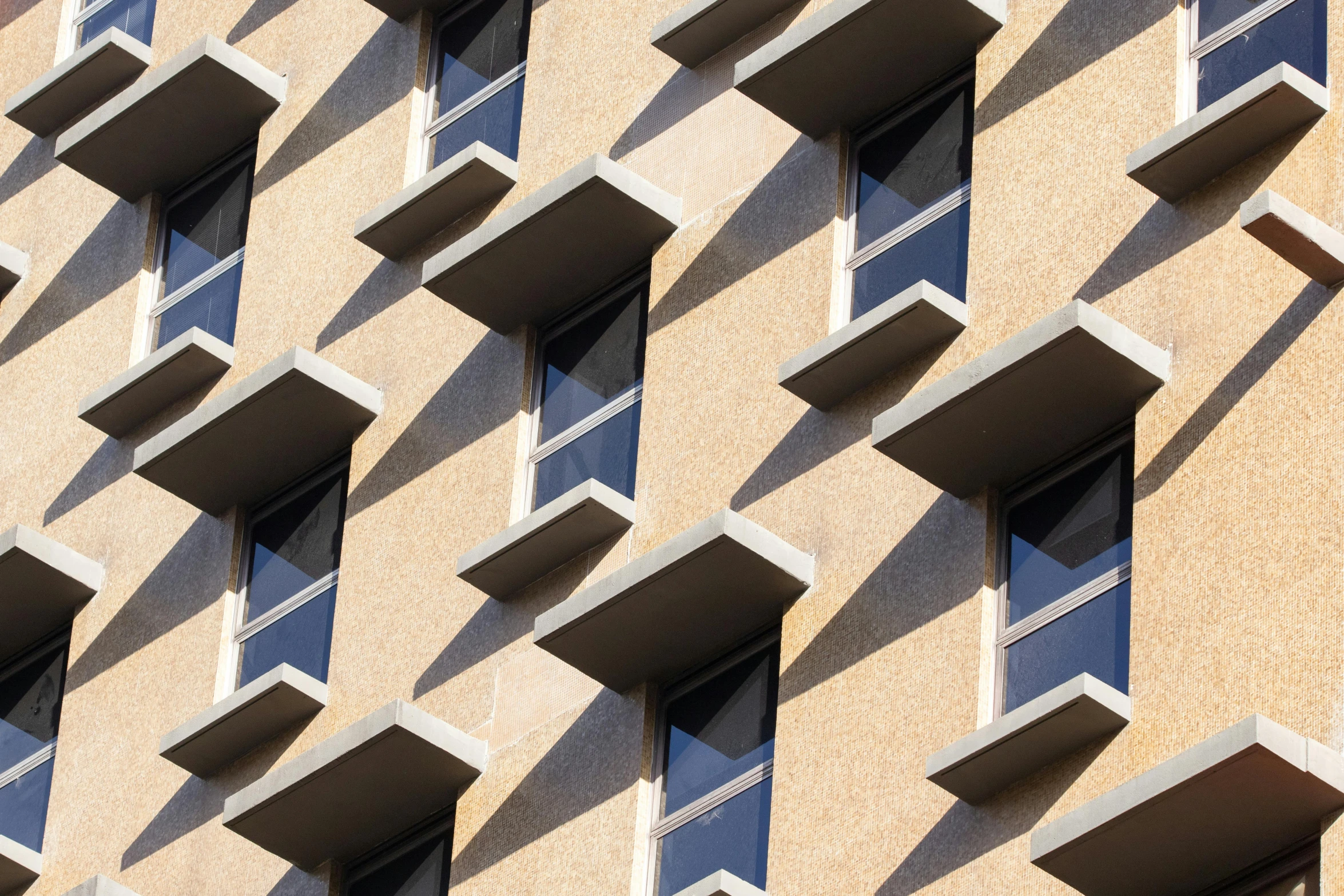 a very tall building with lots of windows, inspired by Ricardo Bofill, unsplash, brutalism, dappled sunlight, brown, window, high-angle