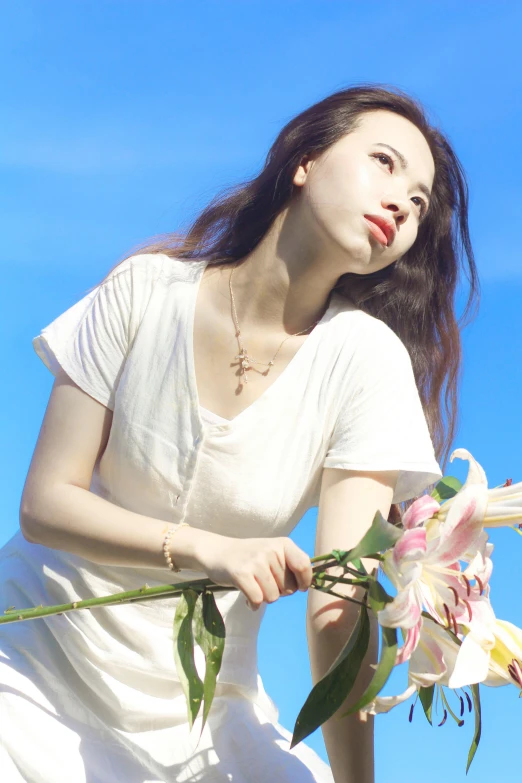 a woman in a white dress holding a bunch of flowers, an album cover, by Ayami Kojima, unsplash, dressed in a white t-shirt, sunny sky, model エリサヘス s from acquamodels, jewelry