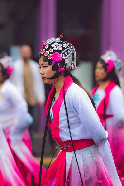 a group of people walking down a street, an album cover, inspired by Miao Fu, pexels contest winner, palace ， a girl in hanfu, wearing a pink head band, profile shot, concert photo