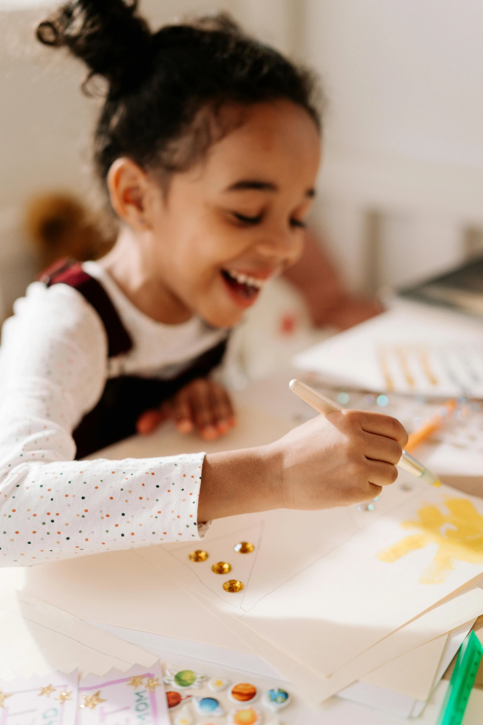 a little girl that is sitting at a table, a child's drawing, pexels contest winner, white and gold color palette, earing a shirt laughing, dot painting, academic painting