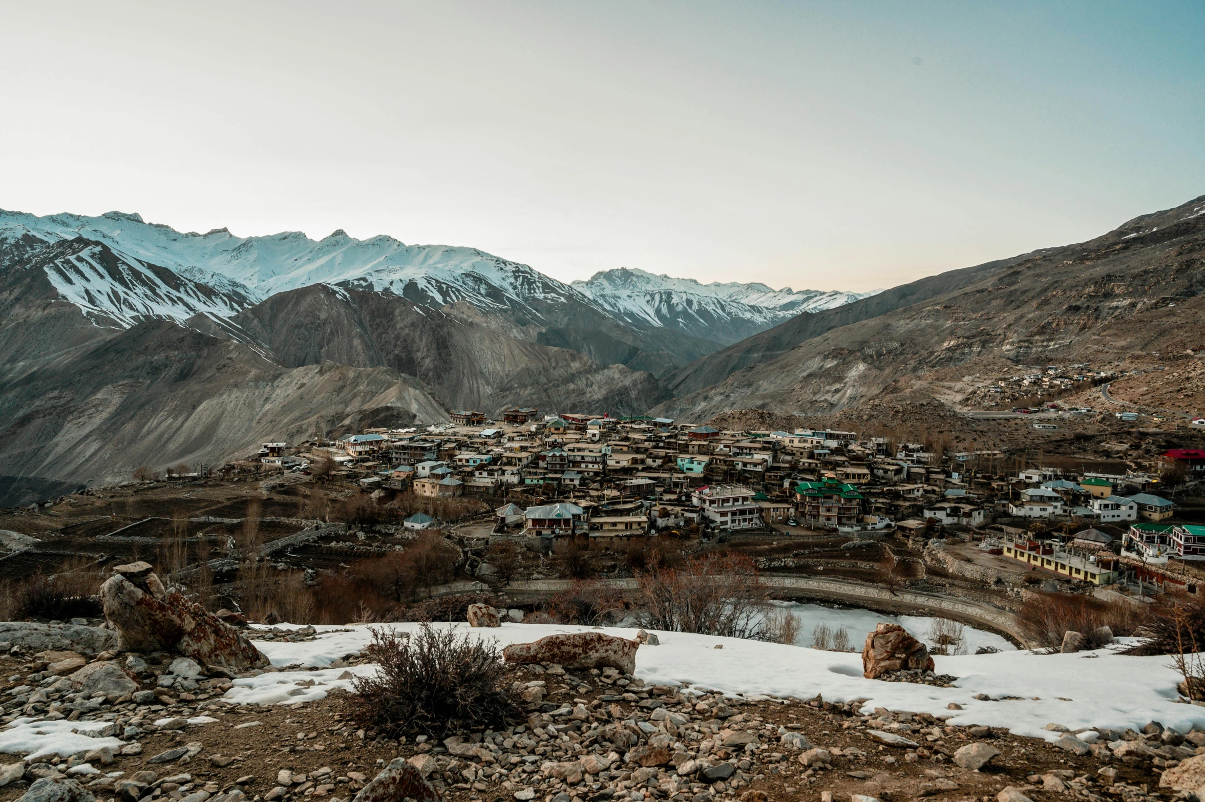 a village in the mountains with snow on the ground, a portrait, trending on unsplash, hurufiyya, anthropology photo”, background image, ash thorp khyzyl saleem, dessert