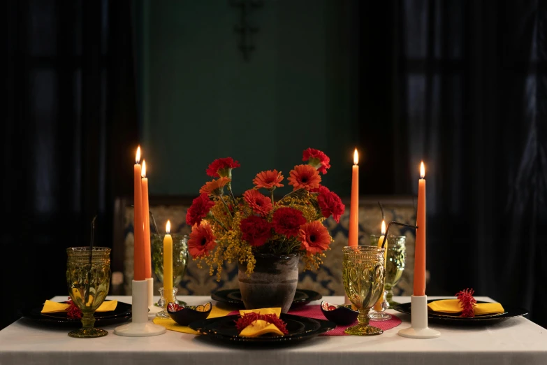 a table that has a bunch of candles on it, by Carey Morris, pexels, scarlet and yellow scheme, mexican, square, moody ambiance