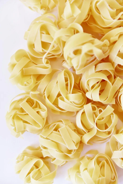 a pile of uncooked pasta on a white surface, by Jessie Algie, square, perfect crisp sunlight, rose petals, no text