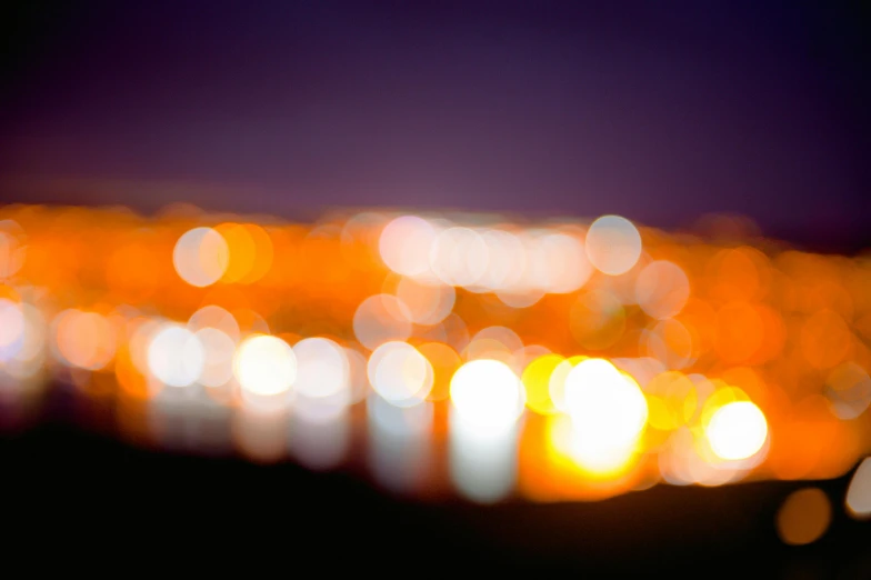 a blurry photo of a city at night, by Jan Rustem, unsplash, art photography, orange glow, bokeh soft, overcast bokeh - c 5, harbor