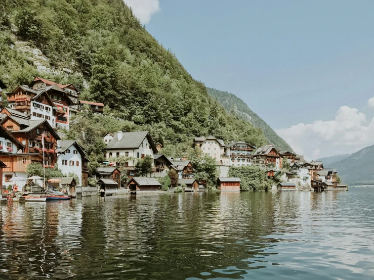 a large body of water filled with lots of houses, by Emma Andijewska, pexels contest winner, alpine architecture, 🦩🪐🐞👩🏻🦳, cottagecore hippie, in the style wes anderson