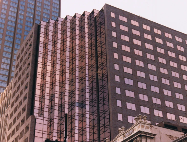 a couple of tall buildings sitting next to each other, a photo, by Tom Phillips, renaissance, ektachrome color photograph, in australia, pink reflections, brown