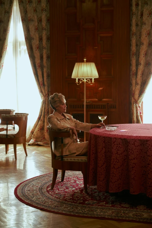 a woman sitting at a table with a glass of wine, an album cover, inspired by Nil Gleyen, in opulent library, film still from the movie, president of belorussia, cinematic long shot