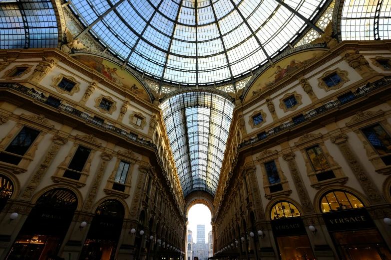 a group of people walking through a shopping mall, a photo, inspired by René Burri, pexels contest winner, renaissance, giant majestic archways, with tall glass skyscrapers, on a great neoclassical square, spaghetti