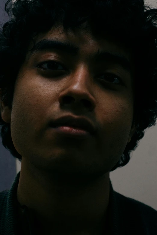 a close up of a person wearing a tie, an album cover, inspired by Jorge Jacinto, unsplash, hyperrealism, curls on top of his head, standing in a dimly lit room, around 1 9 years old, asian face