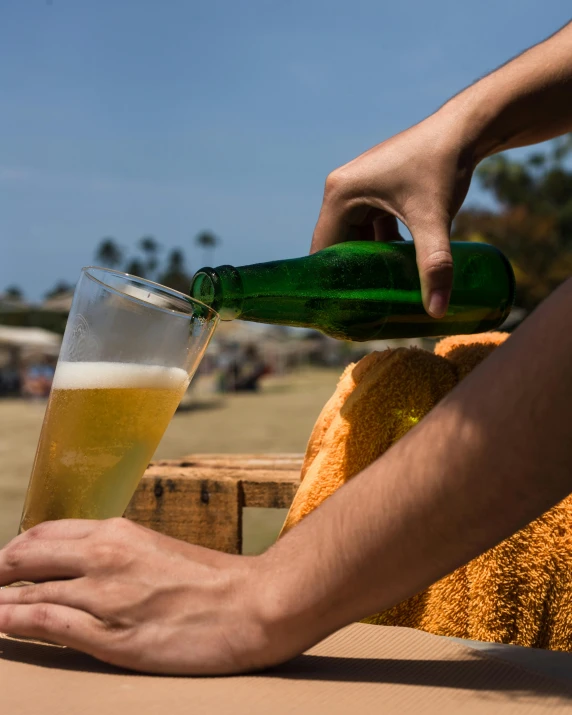 a person pouring a beer into a glass, in the sun, wearing only a green robe, trending photo, lgbtq