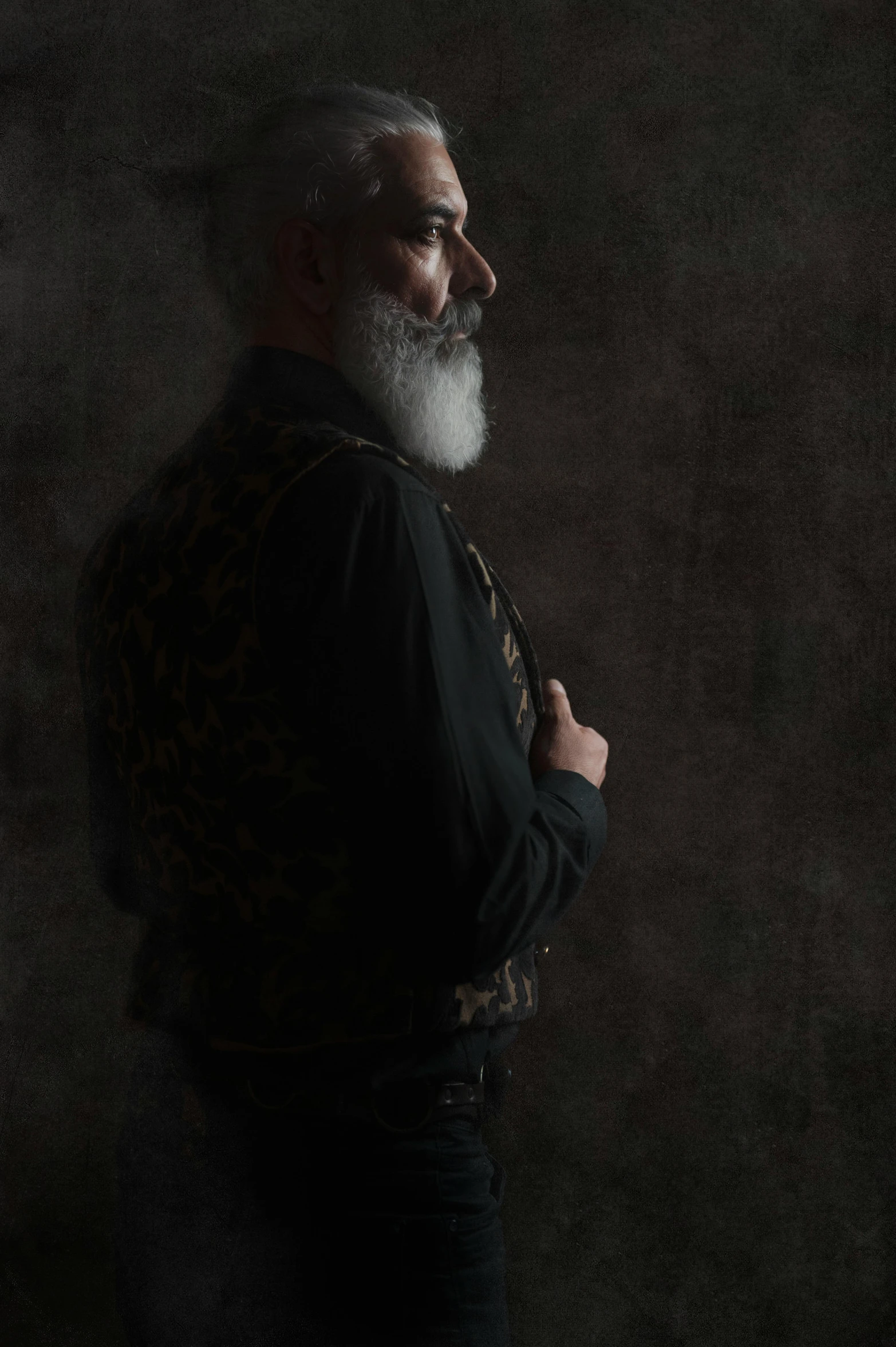 a man with a beard standing in front of a dark background, a character portrait, inspired by Yousuf Karsh, unsplash, renaissance, decorated civil war veteran, white long beard, with his back turned, on a pale background