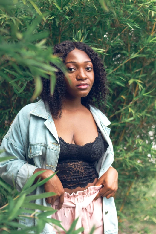 a woman standing in front of a bush, by Stokely Webster, trending on unsplash, renaissance, sexy girl with dark complexion, 2 3 years old, low quality photo, half body cropping