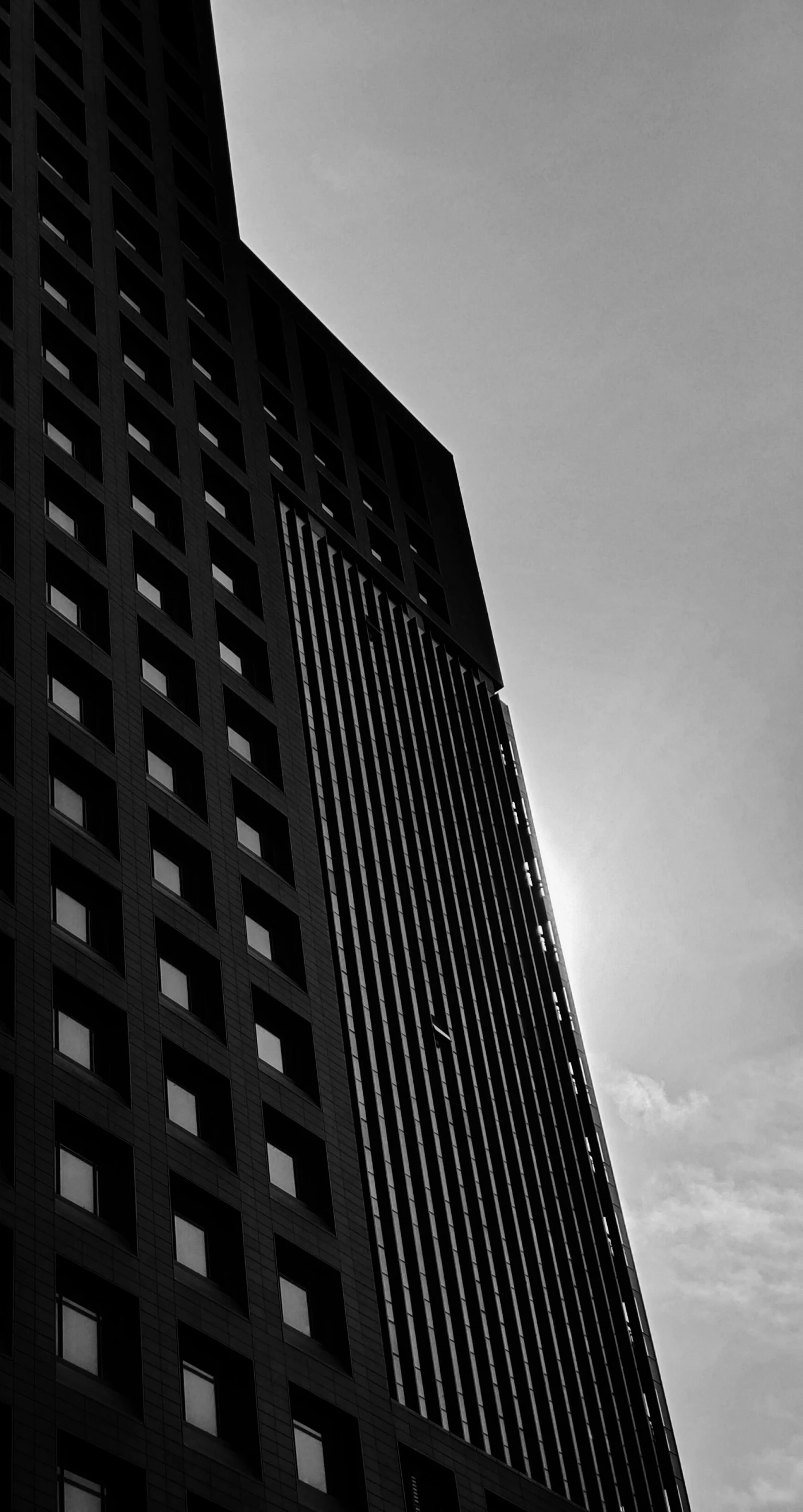 a black and white photo of a tall building, a black and white photo, inspired by David Chipperfield, unsplash, brutalism, hot summer sun, square, dark cityscape, silhouette :7