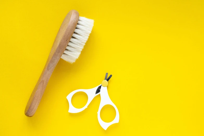 a pair of scissors and a brush on a yellow background, trending on pexels, unclipped fingernails, bushy white beard, photoshop brush, circular