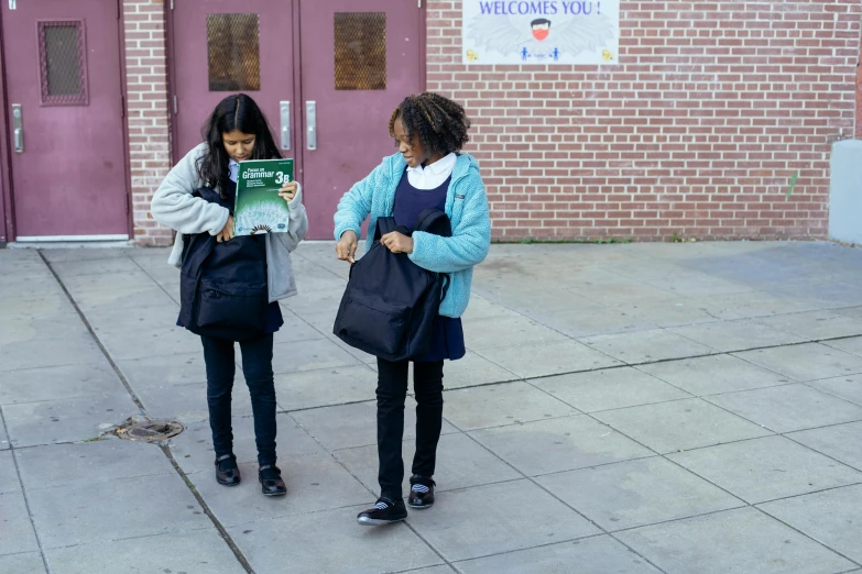 two girls standing next to each other on a sidewalk, pexels contest winner, ashcan school, read a directory book, schomburg, bags on ground, filmstill