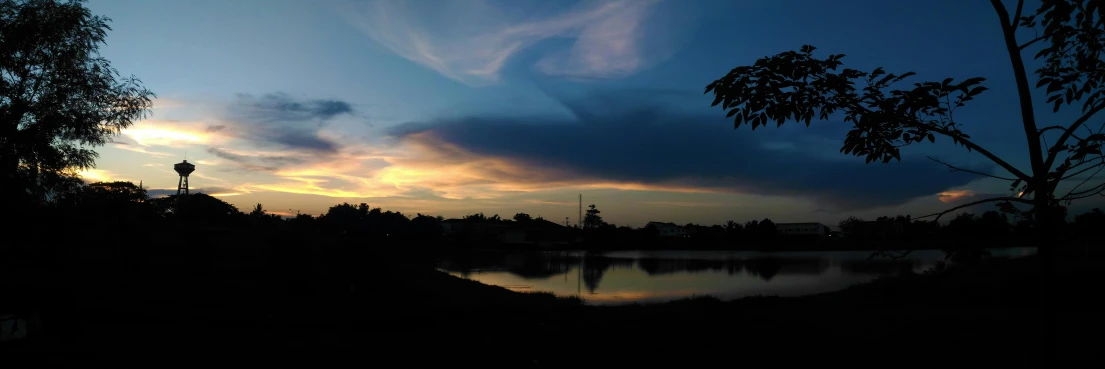 the sun is setting over a body of water, a picture, unsplash, hurufiyya, near a small lake, aesthetic clouds in the sky, cinematic shot ar 9:16 -n 6 -g, night photo