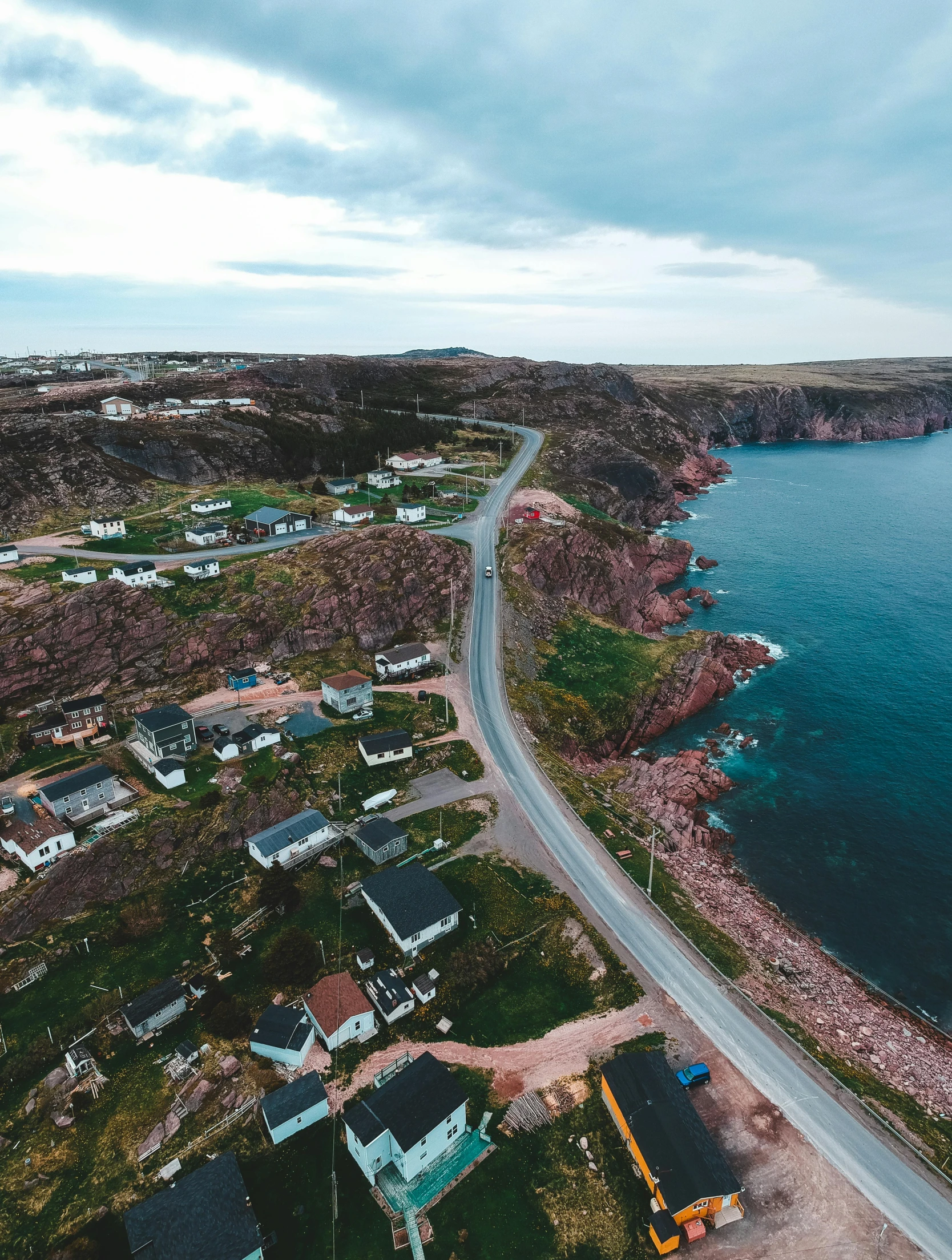 an aerial view of a road next to a body of water, by Kyle Lambert, pexels contest winner, les nabis, cliffside town, profile image, francois legault, coast as the background