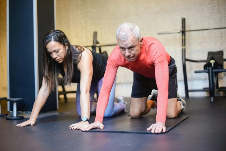 a man and a woman doing push ups in a gym, a portrait, pexels contest winner, two skinny old people, background image, thumbnail, behind the scenes photo