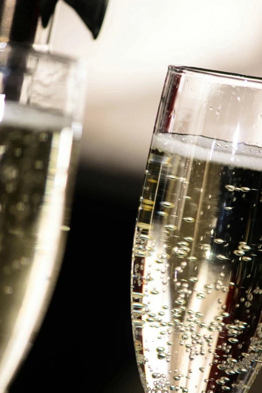 two glasses of champagne sitting next to each other, by John Murdoch, happening, award - winning crisp details ”, bubbles ”, closeup - view, thumbnail