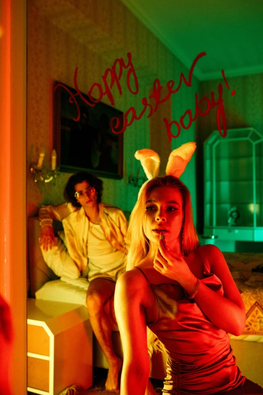 a woman in bunny ears sitting in front of a mirror, an album cover, inspired by David LaChapelle, pop art, couple on bed, easter, dressed anya taylor - joy, high red lights