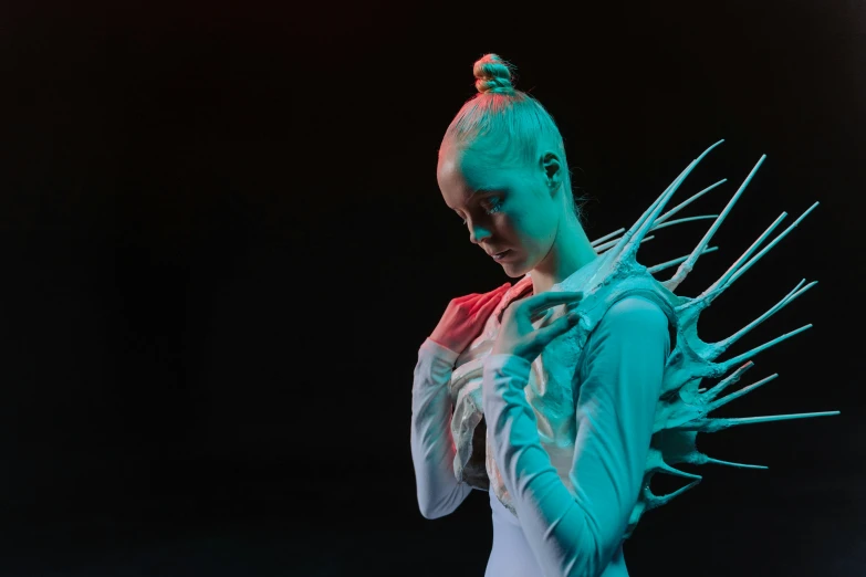 a woman with spiky hair standing in front of a black background, a surrealist sculpture, inspired by Ignacy Witkiewicz, pexels contest winner, video art, neon wings, white cyborg fashion shot, elle fanning as an android, white and teal garment