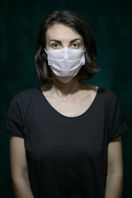 a woman wearing a face mask in a dark room, an album cover, inspired by Elke Vogelsang, hyperrealism, uncropped, healthcare worker, ilustration, 60mm portrait