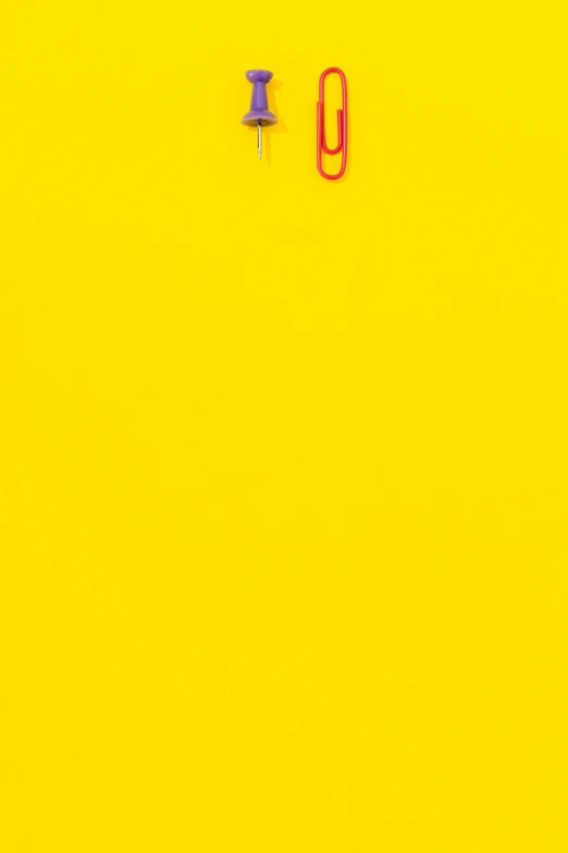 a pair of scissors sitting on top of a yellow surface, by Peter Alexander Hay, postminimalism, red yellow, hanging, pop colors, kim hyun joo