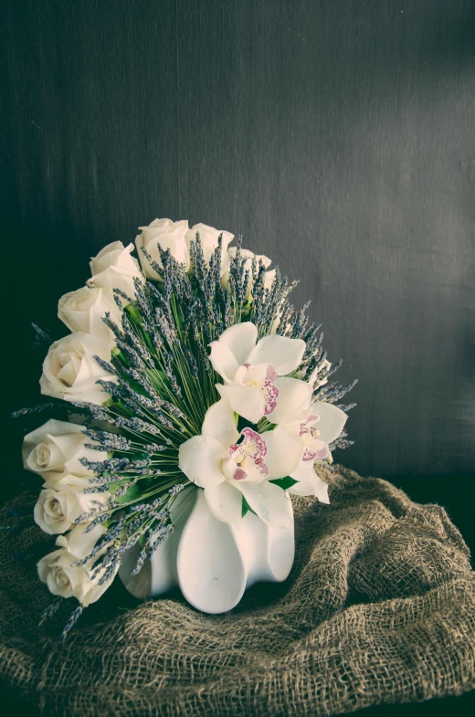 a white vase with a bunch of flowers in it, inspired by François Boquet, baroque, white spiral horns, overgrown with thick orchids, premium, white roses