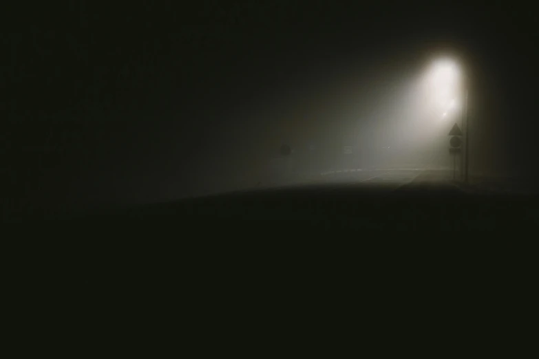 a couple of people that are standing in the dark, a picture, unsplash contest winner, light and space, dense ground fog, car lights, nadav kander, floodlight