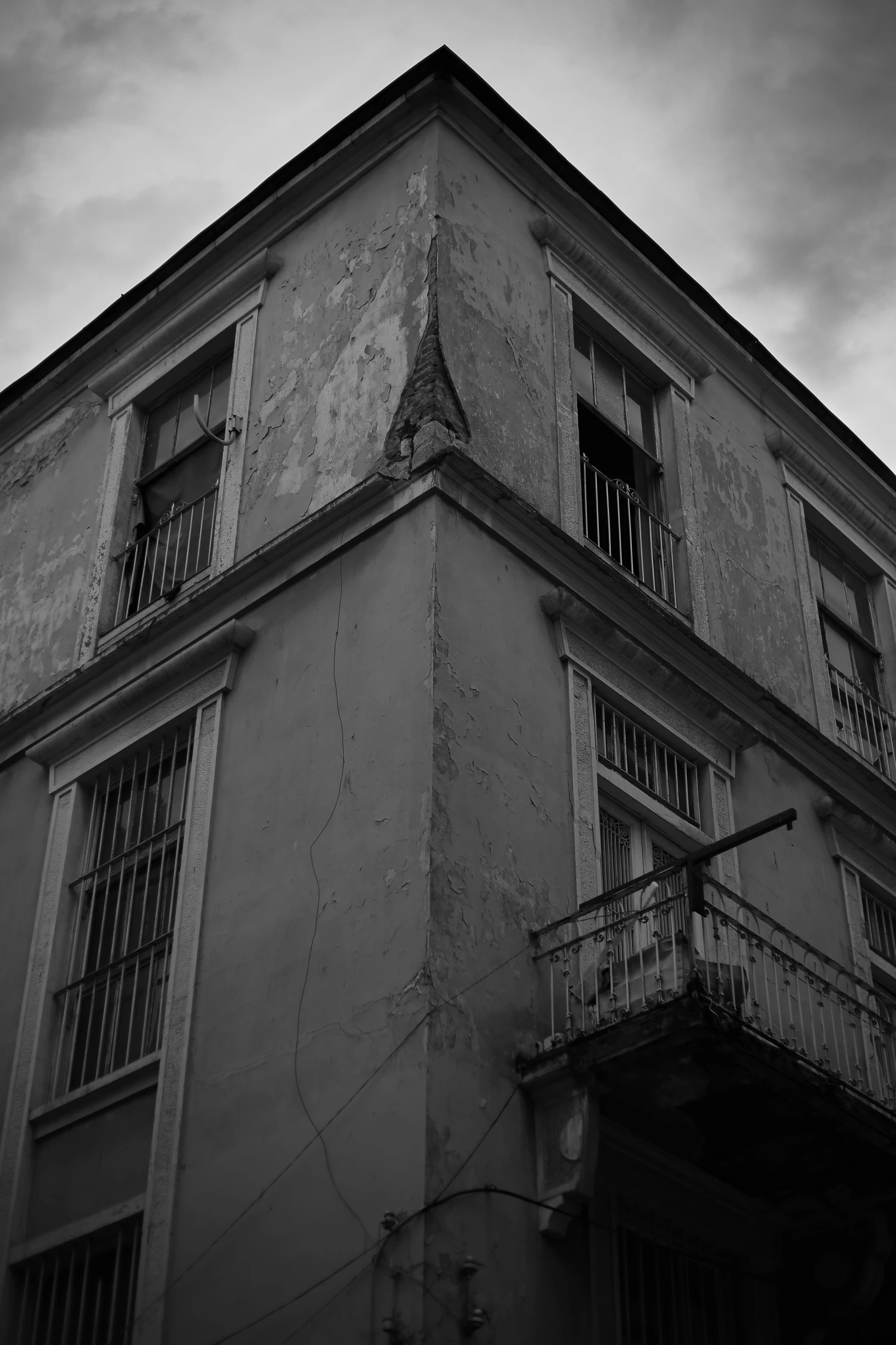 a black and white photo of an old building, a black and white photo, by Altichiero, terrified, in savannah, beaten city. neo noir style, in a square