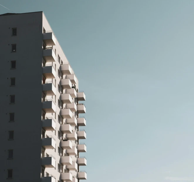 a man riding a skateboard up the side of a tall building, a screenshot, pexels contest winner, brutalism, white buildings, seen from a distance, clemens ascher, soviet apartment building