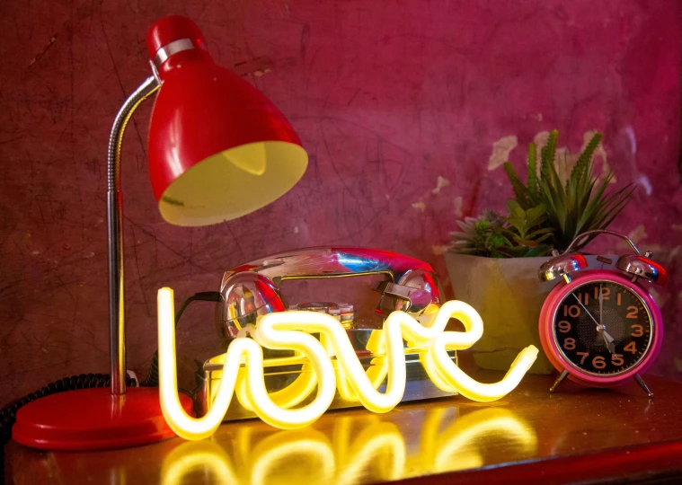 a lamp sitting on top of a table next to a clock, graffiti, neon pink, smokey burnt love letters, red and yellow light, neon inc