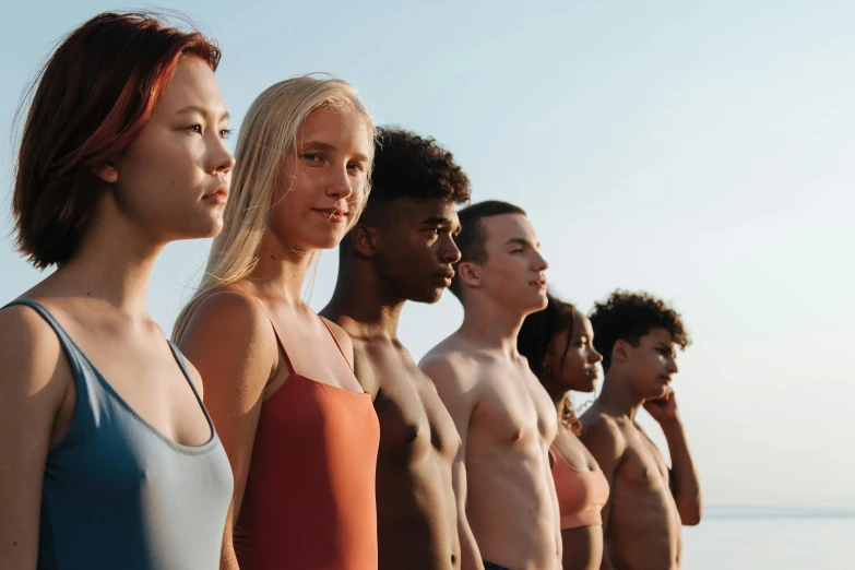 a group of people standing next to each other on a beach, face and body features, light skin tone, frank moth, various colors