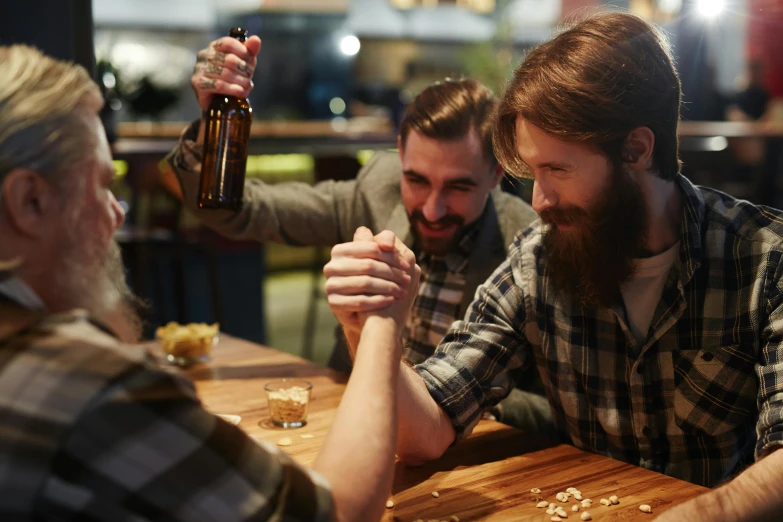 a group of men sitting around a wooden table, pexels contest winner, drunken fist, aussie baristas, game, two men hugging