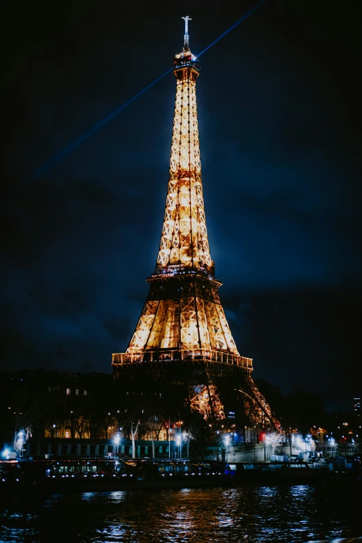 the eiffel tower is lit up at night, pexels contest winner, full screen, low detail, high quality upload, gif