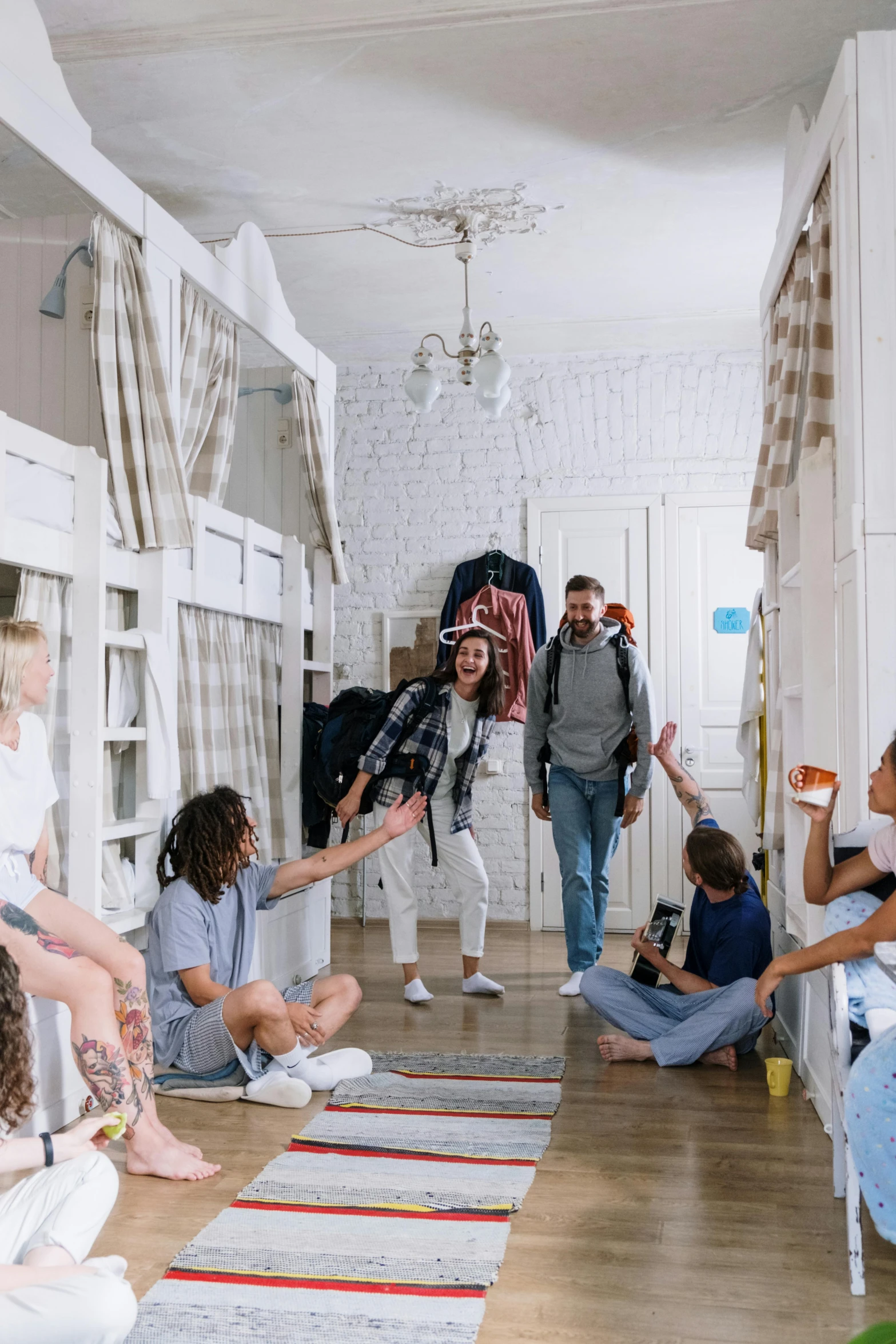 a group of people in a room with bunk beds, pexels contest winner, long hall way, all overly excited, afternoon hangout, panoramic shot