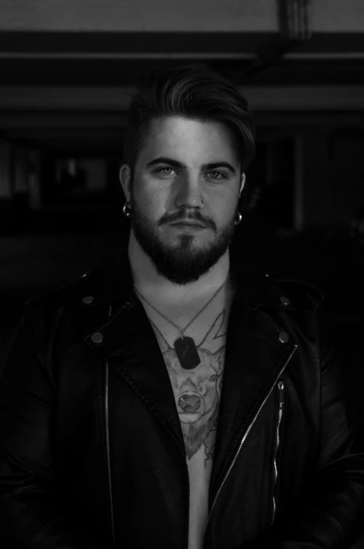 a black and white photo of a man in a leather jacket, inspired by Cam Sykes, neckbeard, official music video, (night), wolf o'donnell