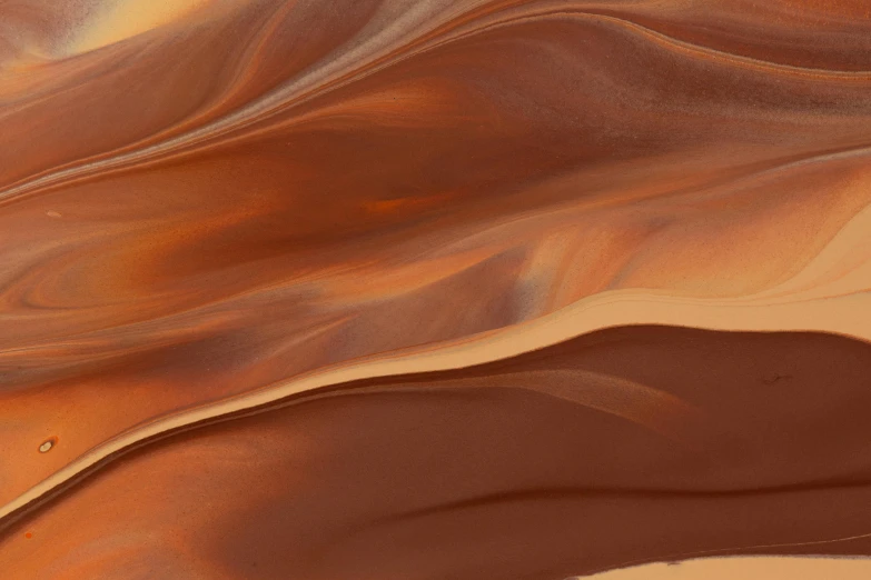 a man riding a surfboard on top of a sandy beach, inspired by Anna Füssli, trending on pexels, lyrical abstraction, shiny layered geological strata, fully chocolate, uluru, close-up from above