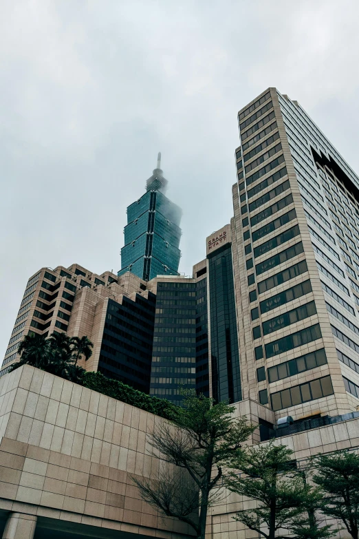a group of tall buildings sitting next to each other, taiwan, modernist buildings, commercially ready, perched on a skyscraper