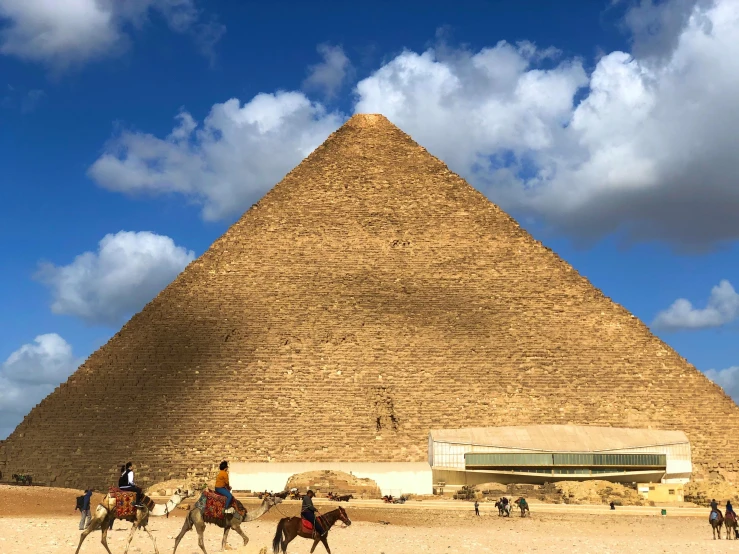 a group of people riding horses in front of a pyramid, egyptian art, pexels contest winner, blue sky, epicurious, 🚿🗝📝, profile image