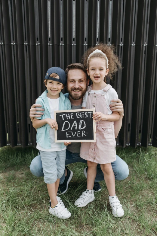 a man and two children holding a sign that says the best dad ever, pexels contest winner, lachlan bailey, chalkboard, instagram post, a handsome