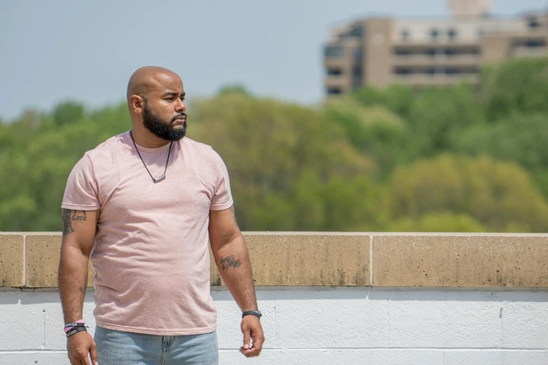 a man riding a skateboard down a sidewalk, inspired by George Barret, Jr., standing on a rooftop, with backdrop of natural light, riyahd cassiem, full figured