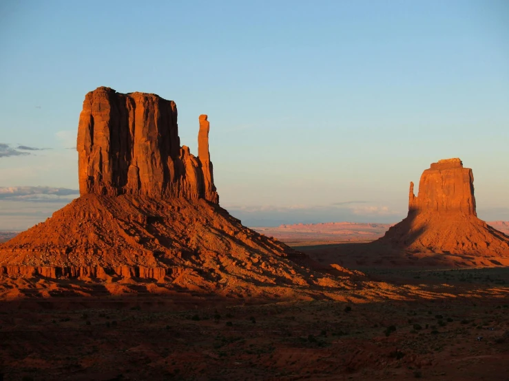 a large rock formation in the middle of a desert, by Linda Sutton, pexels contest winner, two giant towers, evening sunlight, avatar image