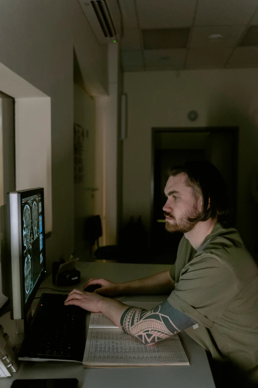 a man sitting at a desk using a laptop computer, computer graphics, by Adam Marczyński, reddit, mri, long cinematic shot, portrait of gigachad, looking at monitor