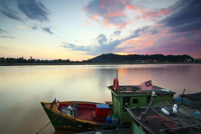 a couple of boats that are sitting in the water, unsplash contest winner, sumatraism, colourful sky, beside a river, lim chuan shin, slide show