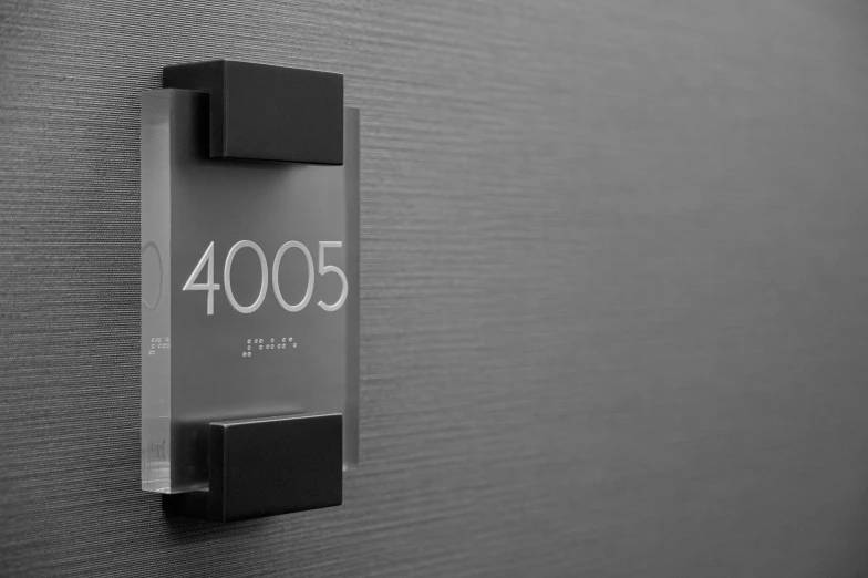 a close up of a clock on a wall, black 3 d cuboid device, frosted glass, 4 2 0 0 k, sign that says 1 0 0